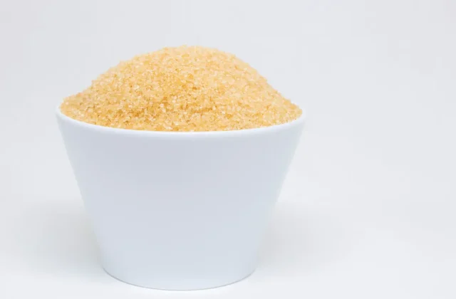 A white bowl of golden date sugar