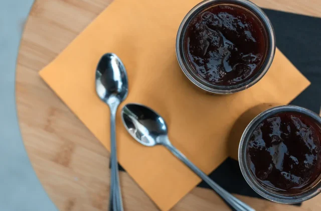 Dark date syrup in small dishes with spoons