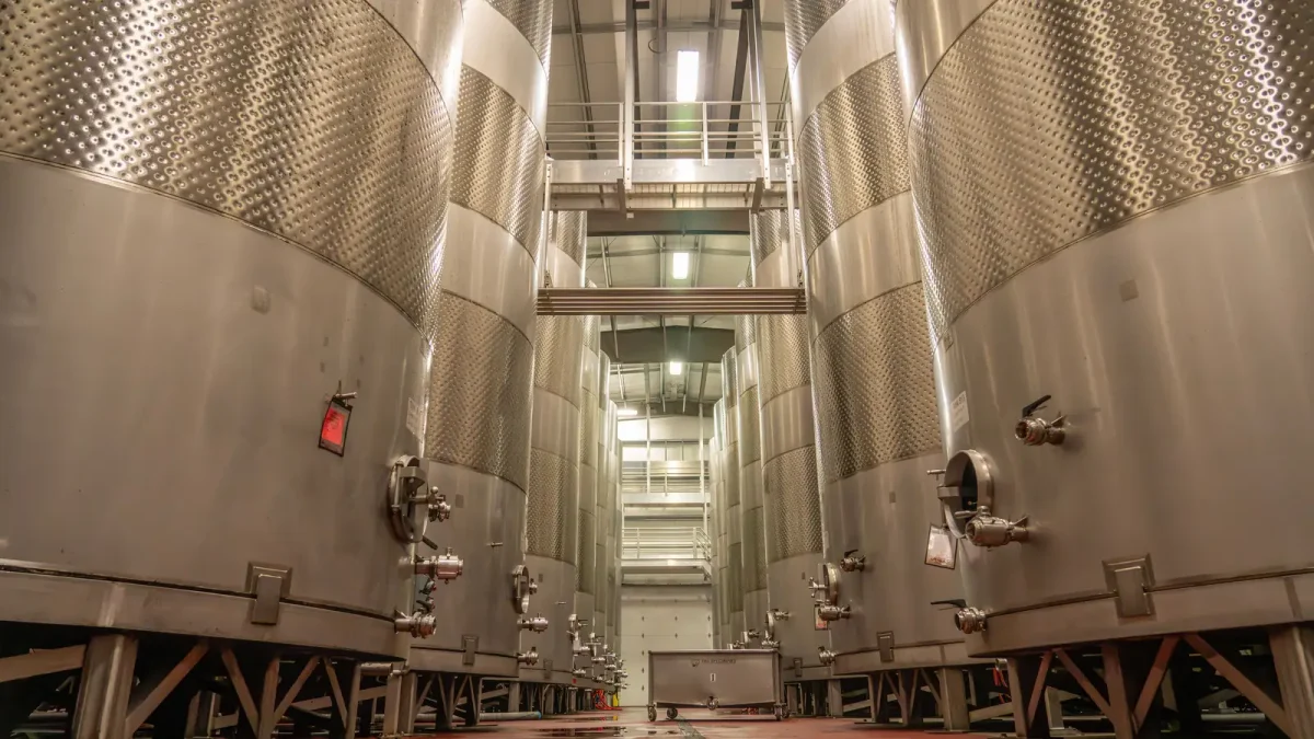 Rows of stainless steel tanks in an oil production facility