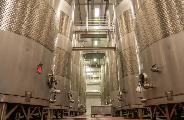 Rows of stainless steel tanks in an oil production facility