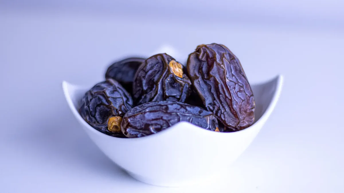 Pitted dates in a white bowl