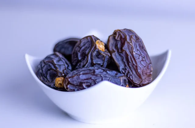Pitted dates in a white bowl