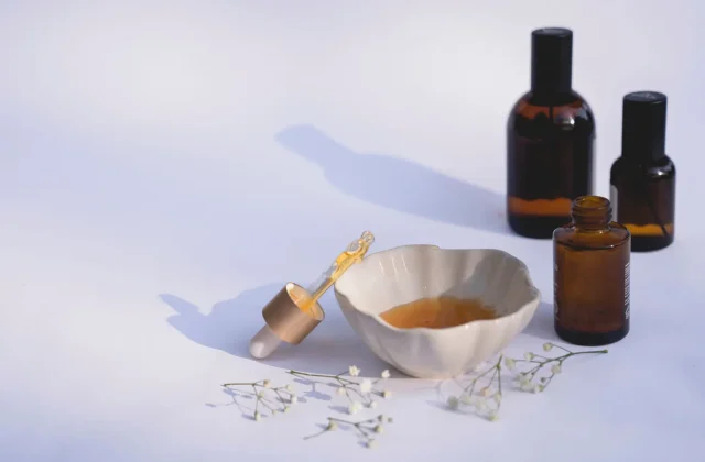 Amber bottles of prickly pear seed oil with seeds