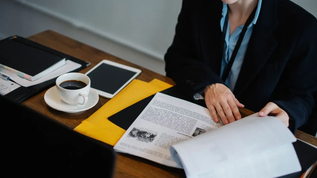 A person reviewing a printed document at a desk