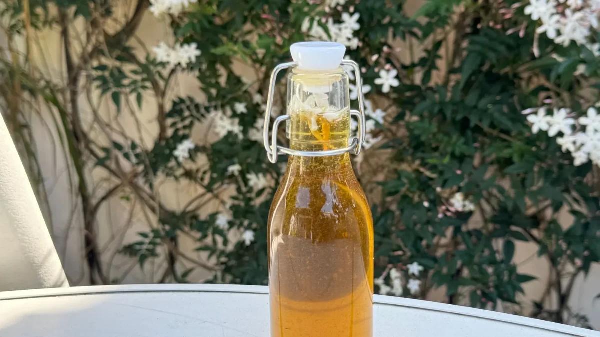 A swing-top glass bottle of golden olive oil