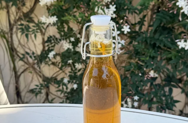 A swing-top glass bottle of golden olive oil